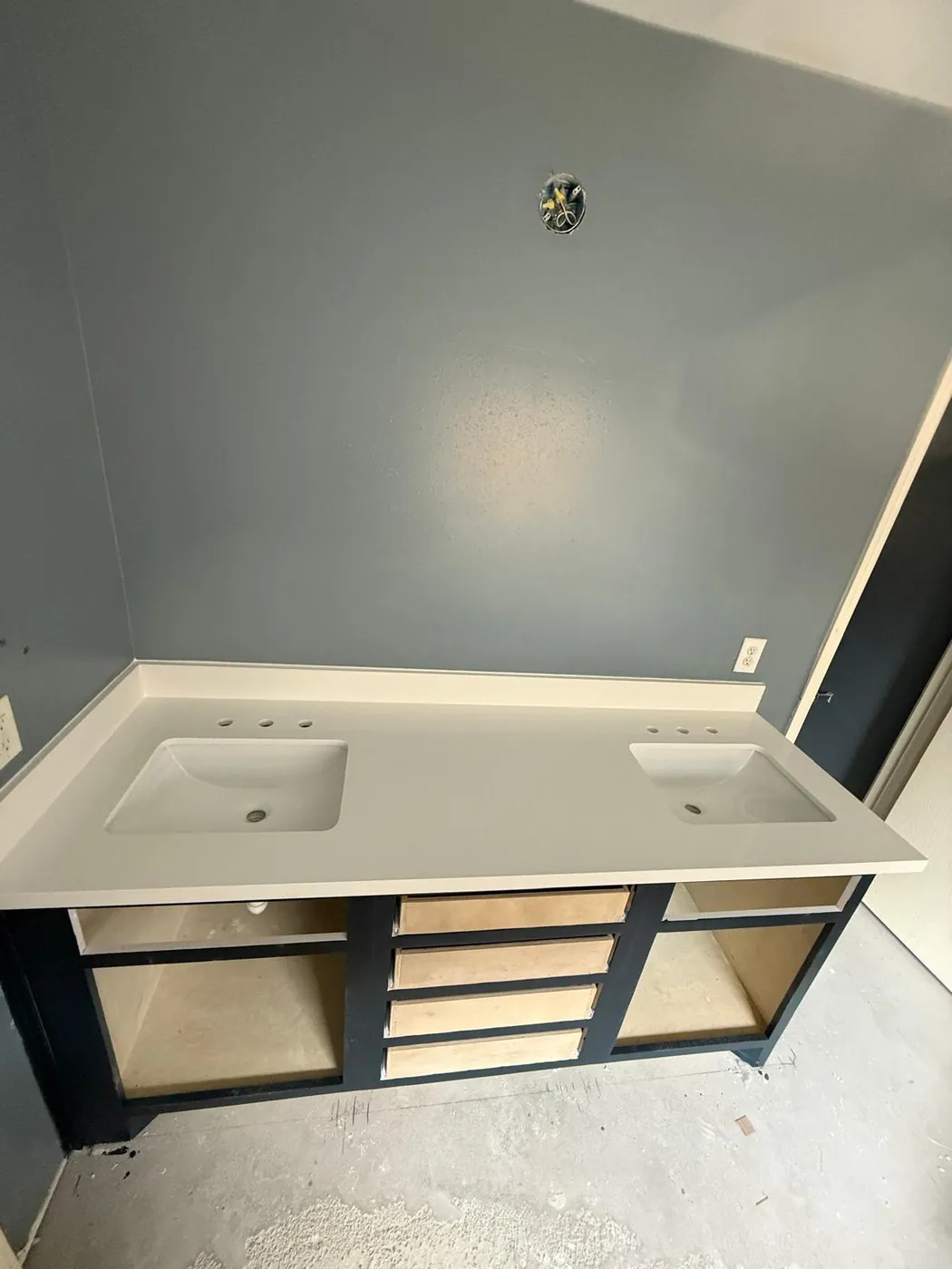 During: the double vanity built and set, ready for its counter.