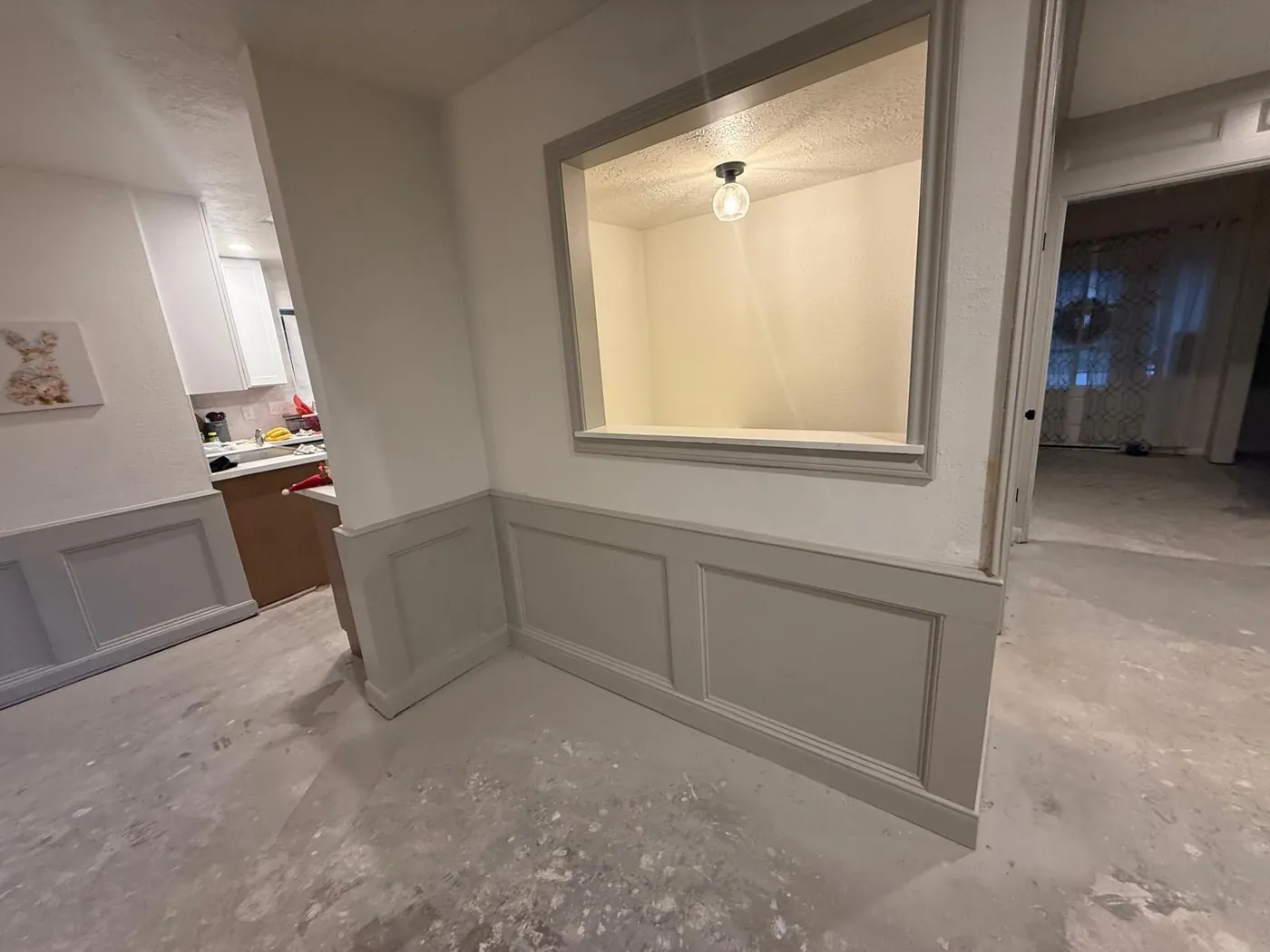 Wainscoting and a new interior window opening up the family room.