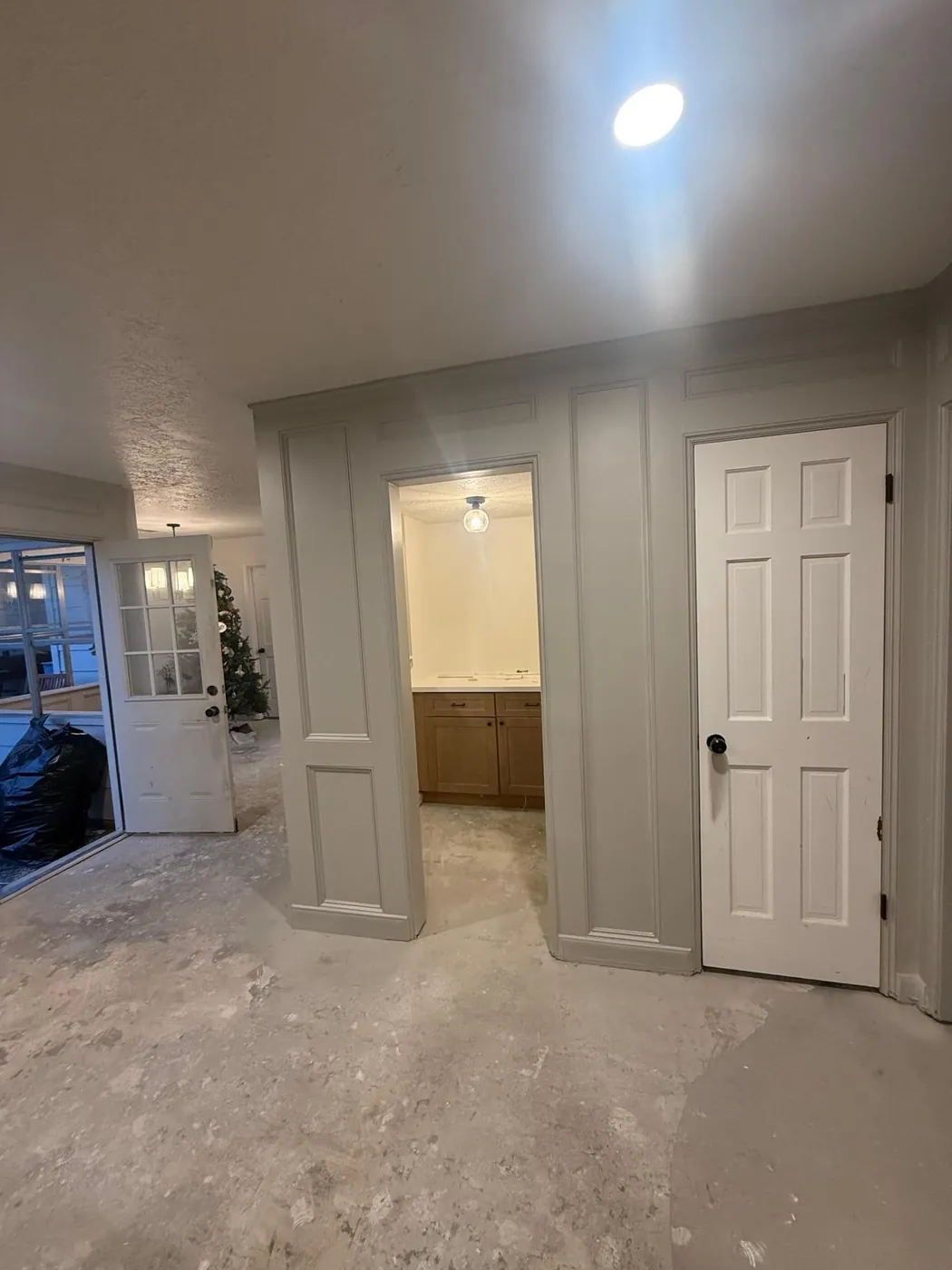Cased openings and new doors framing the hallway.