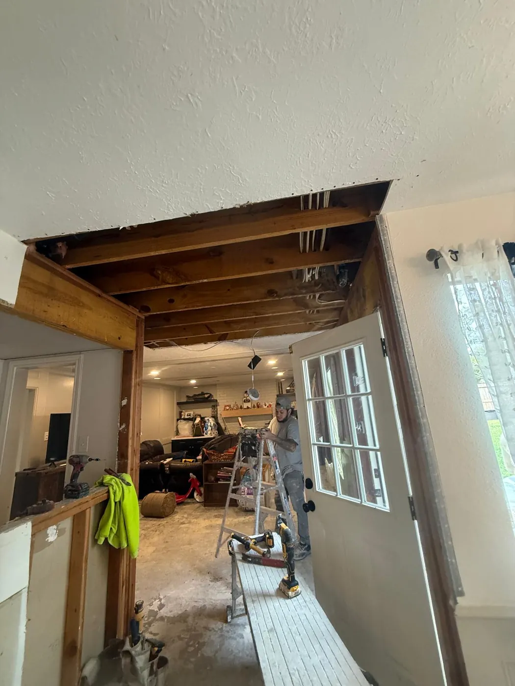 Down to the joists — the structure checked before anything gets covered.